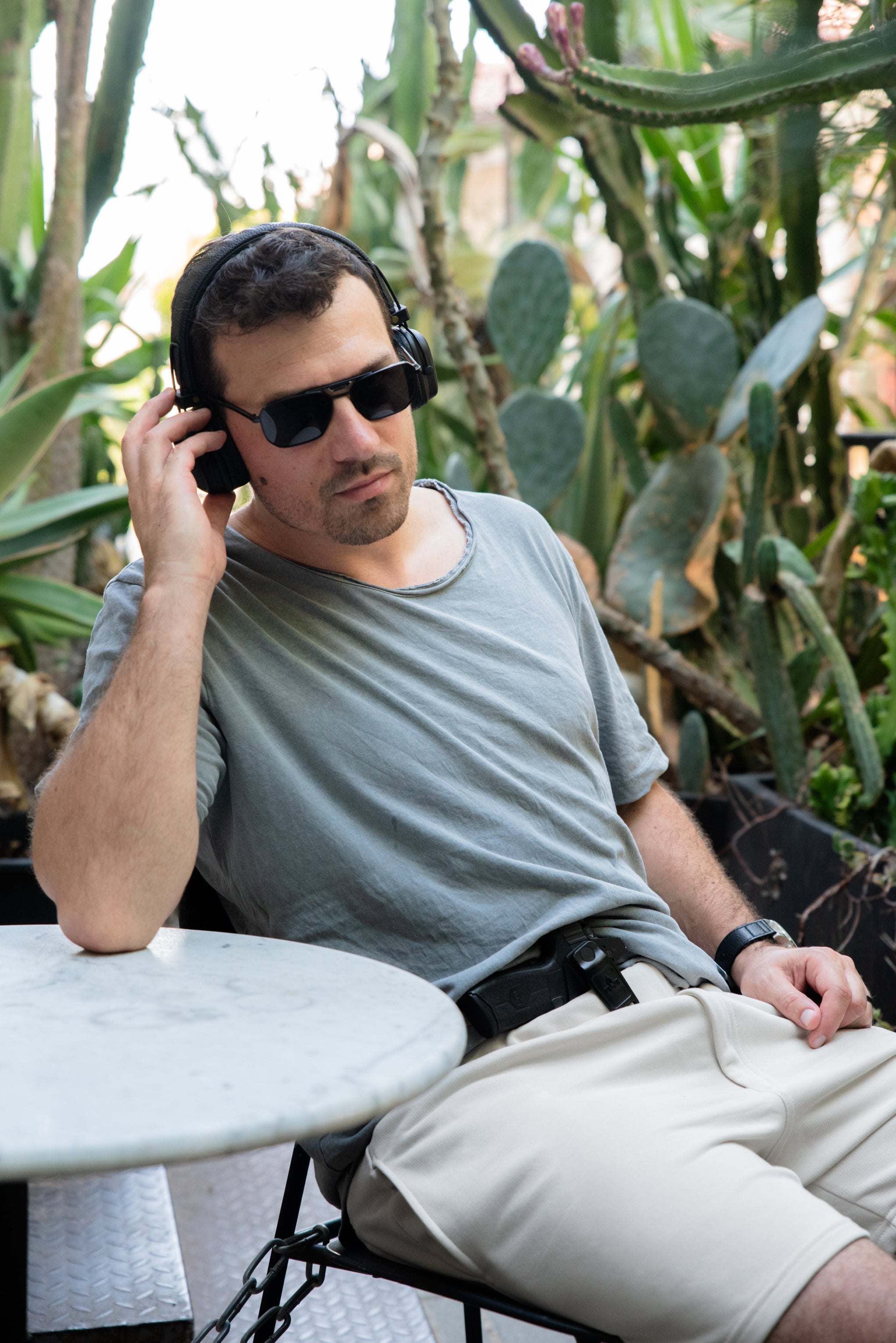 Man sitting outdoors with cacti in the background